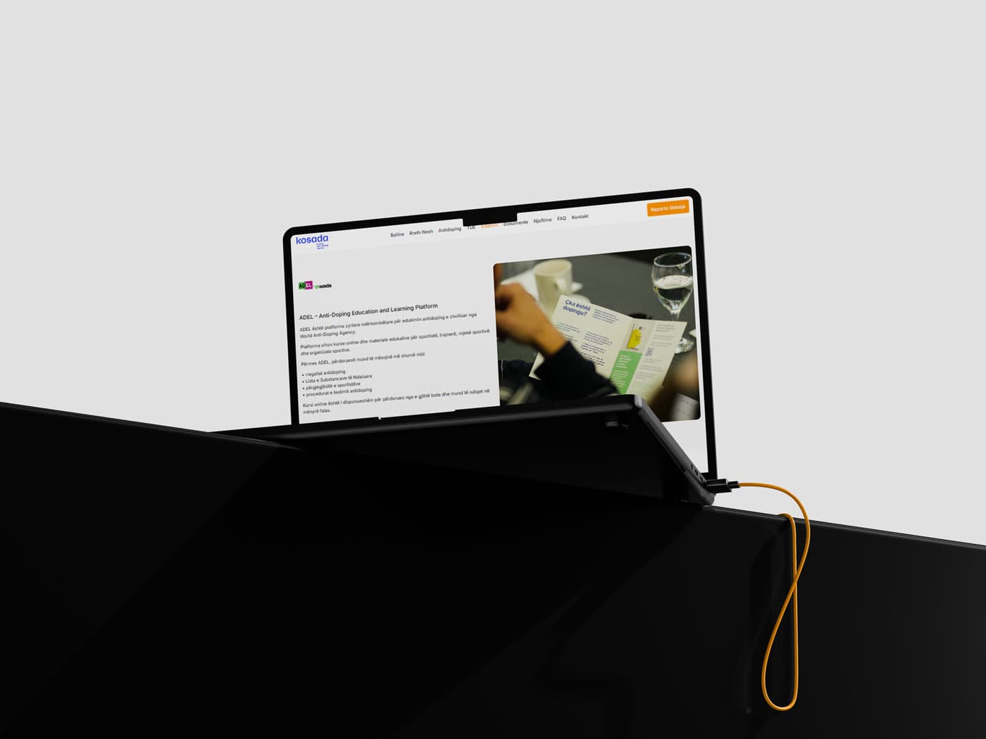 Showing kosADA website on laptop